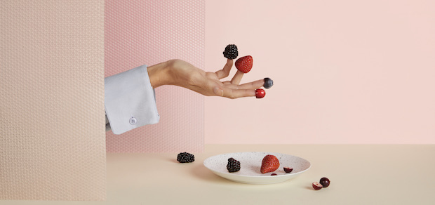 Hand and dish with berries