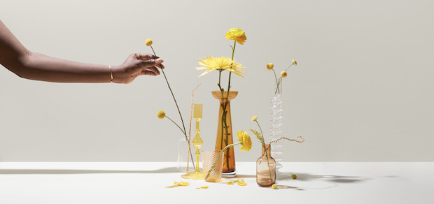 person's hand arranging flowers