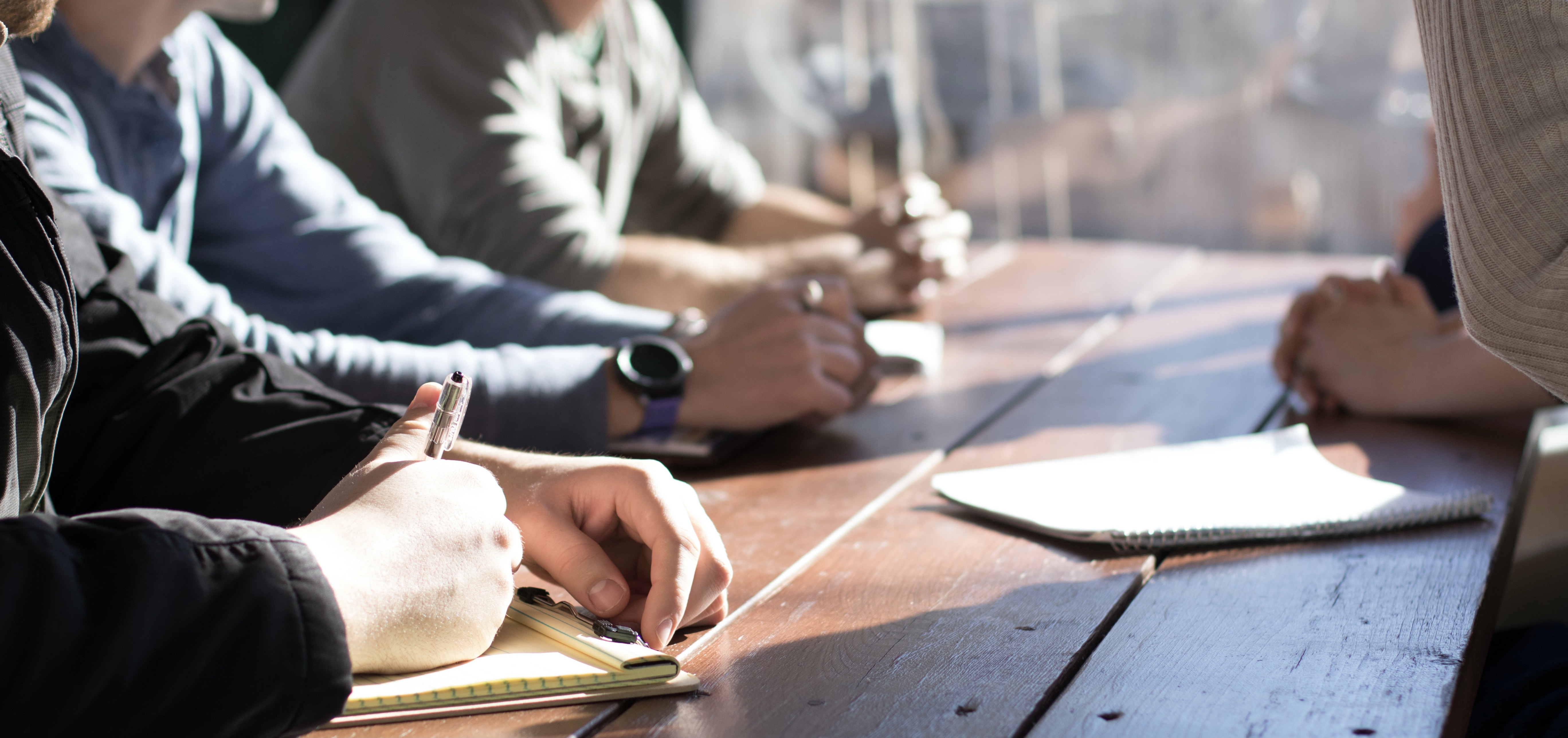 coworkers sitting around a table in a business meeting