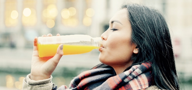 woman drinking orange juice