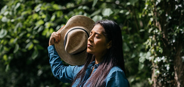 woman fanning herself with her hat