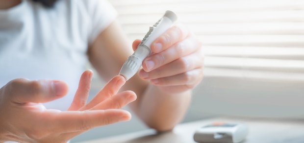 a woman checking her blood sugar level