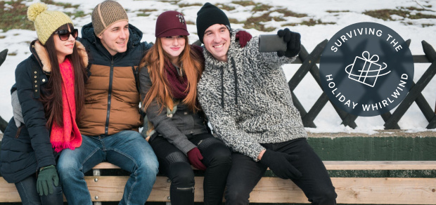 A group of friends ice skating at an outdoor rink, smiling for a selfie