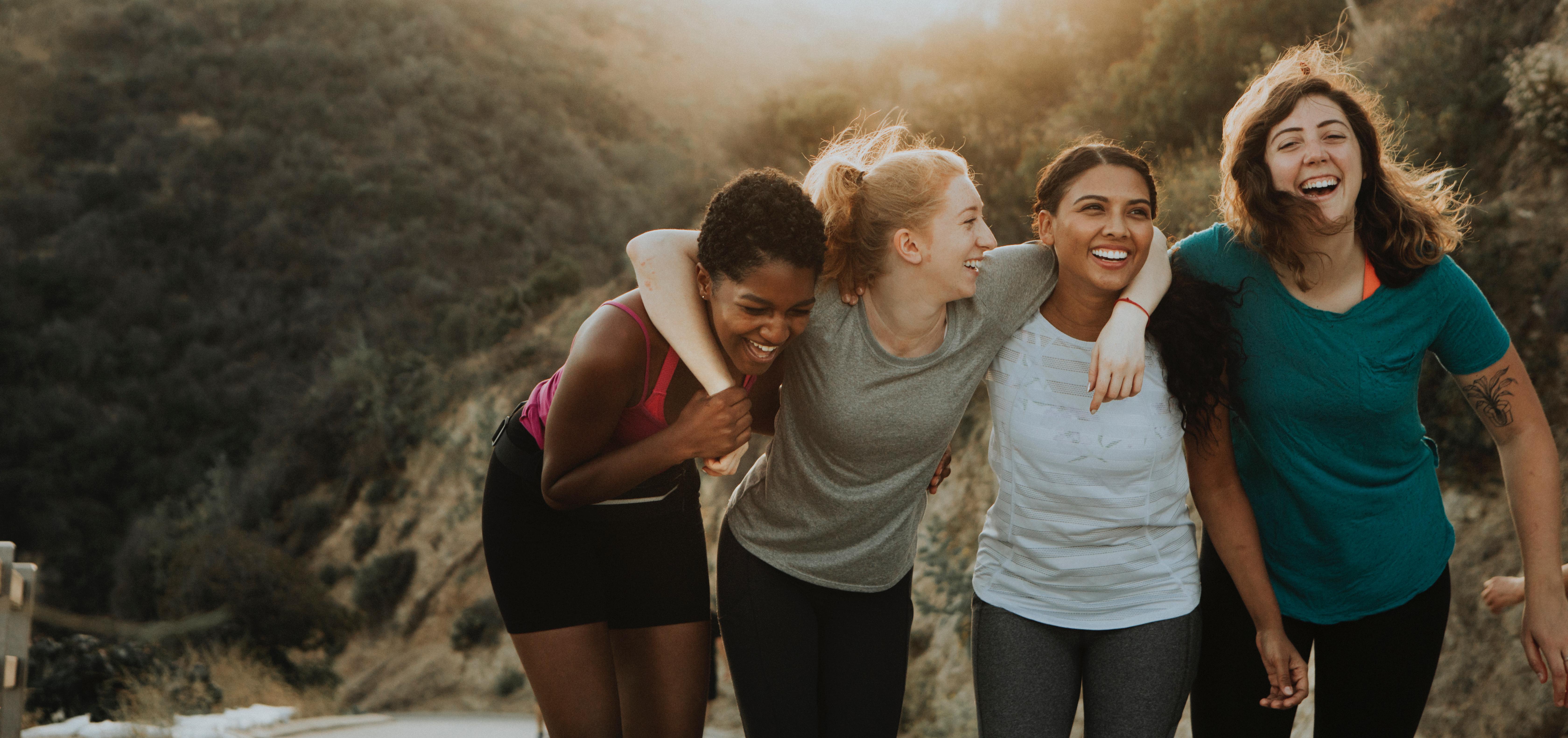 group of friends laughing and smiling outdoors