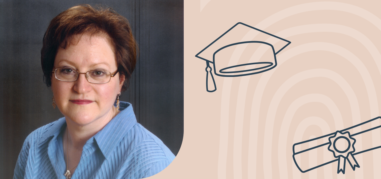 Woman with cap and gown and diploma.