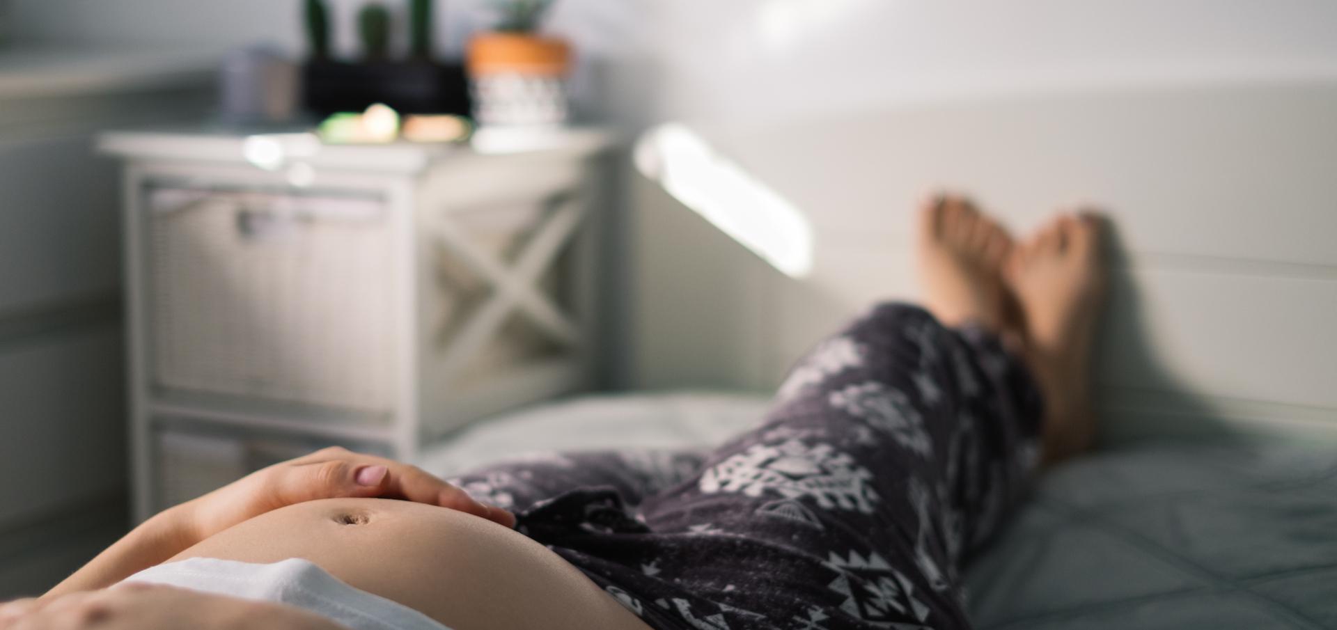 pregnant person lying down with feet up. 