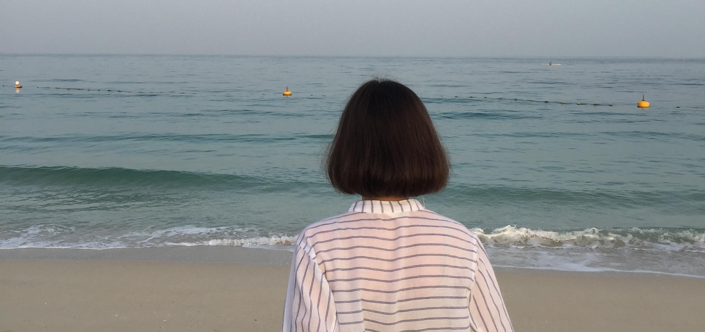 woman staring out into the ocean