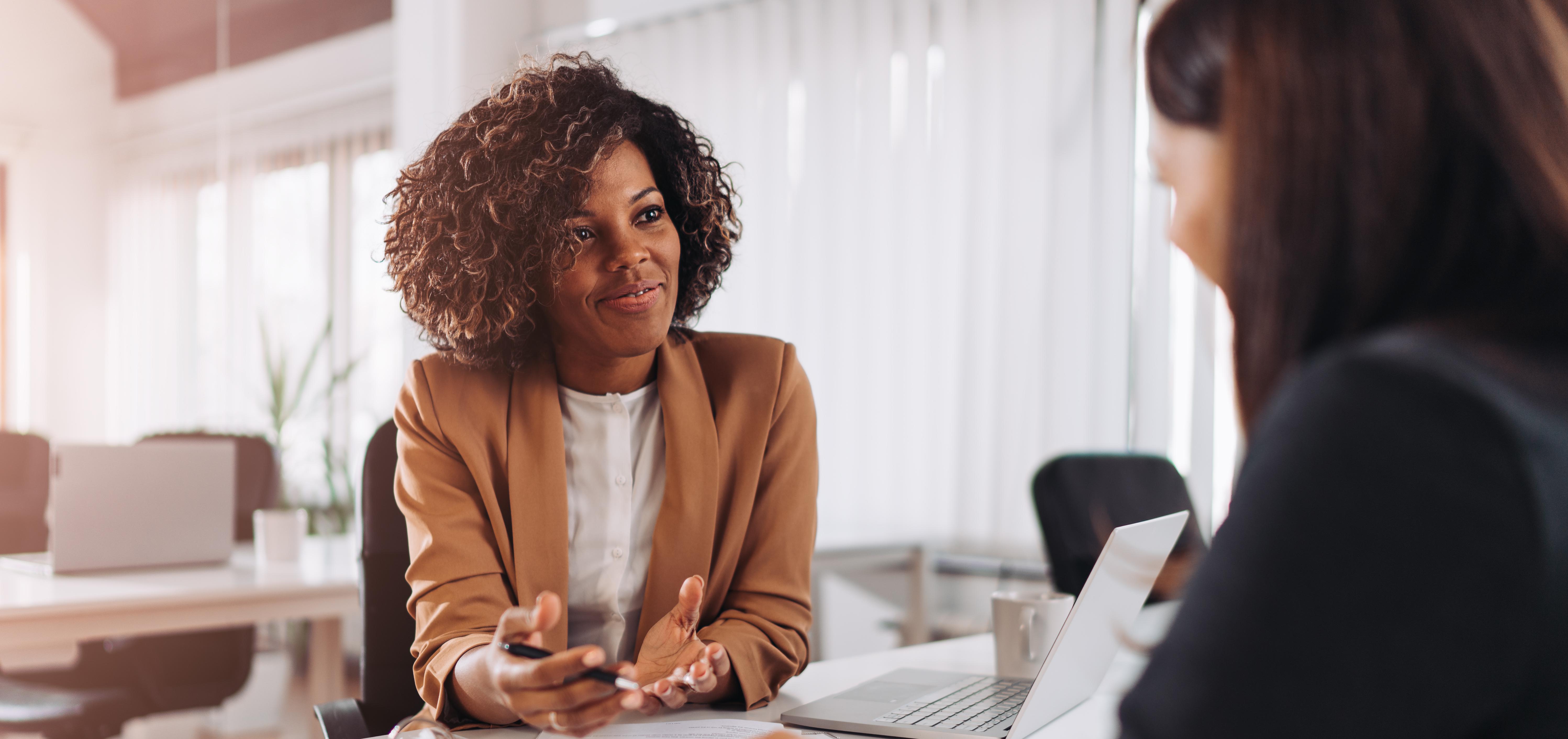 two women talking in the office