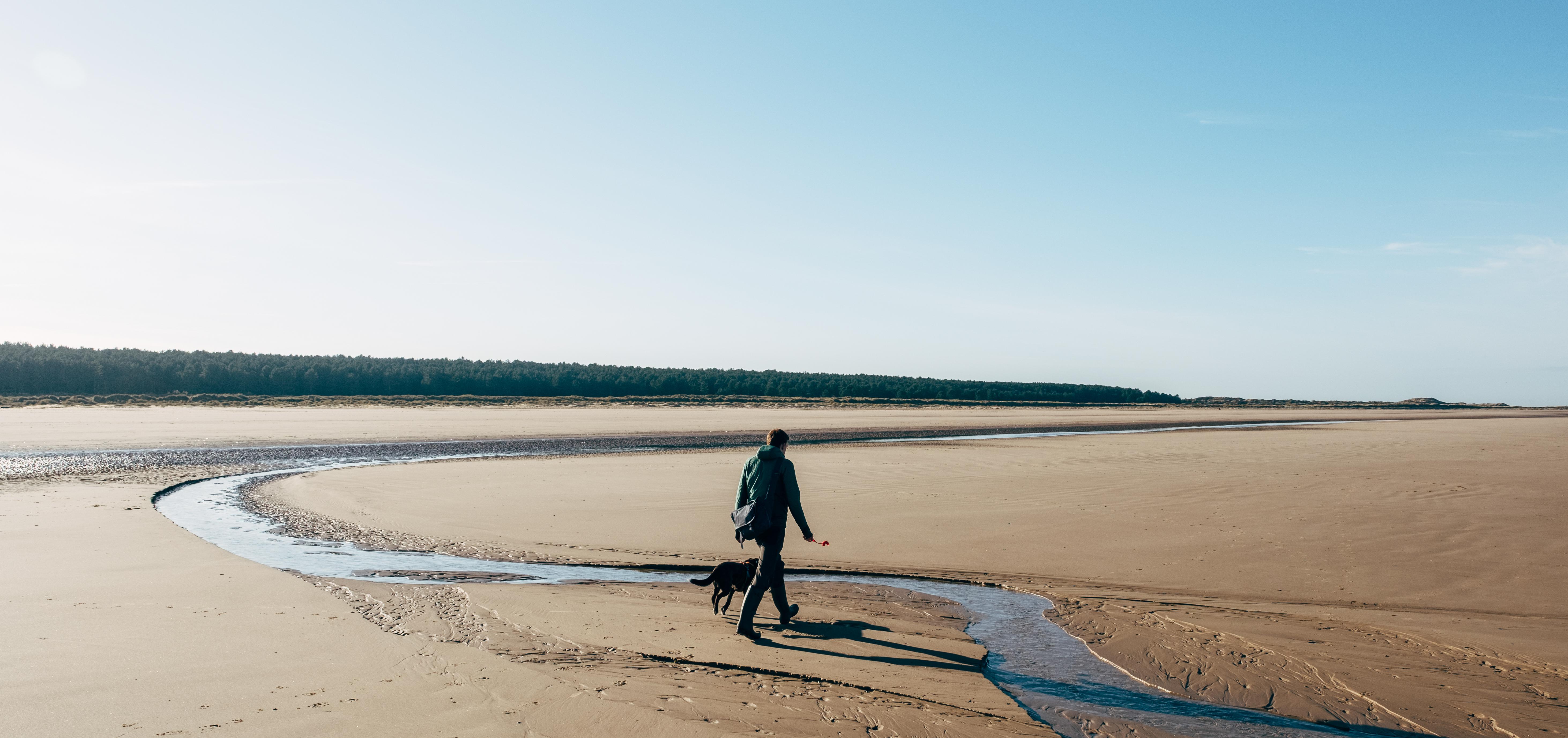 man walking his dog outside