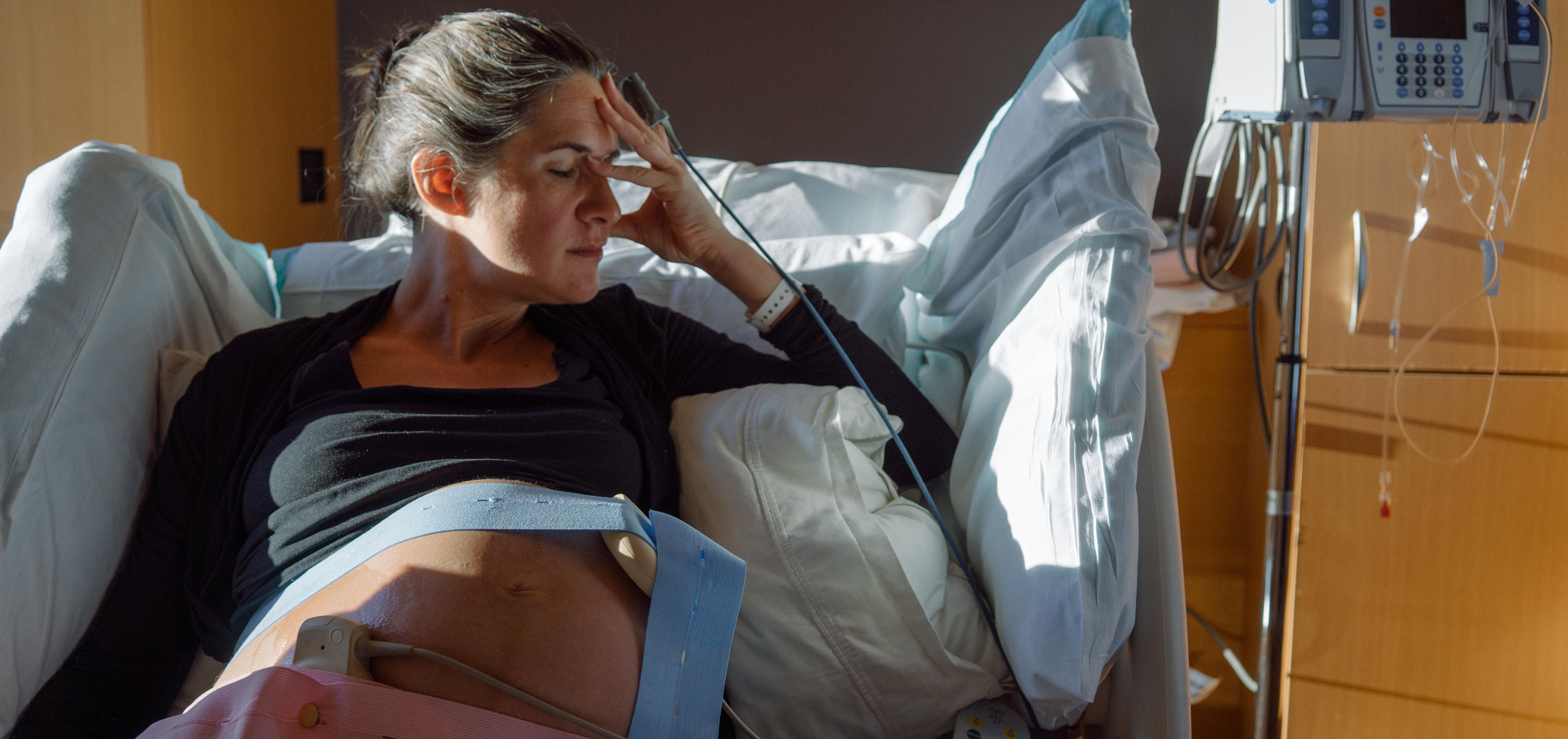 pregnant woman lying in a hospital bed