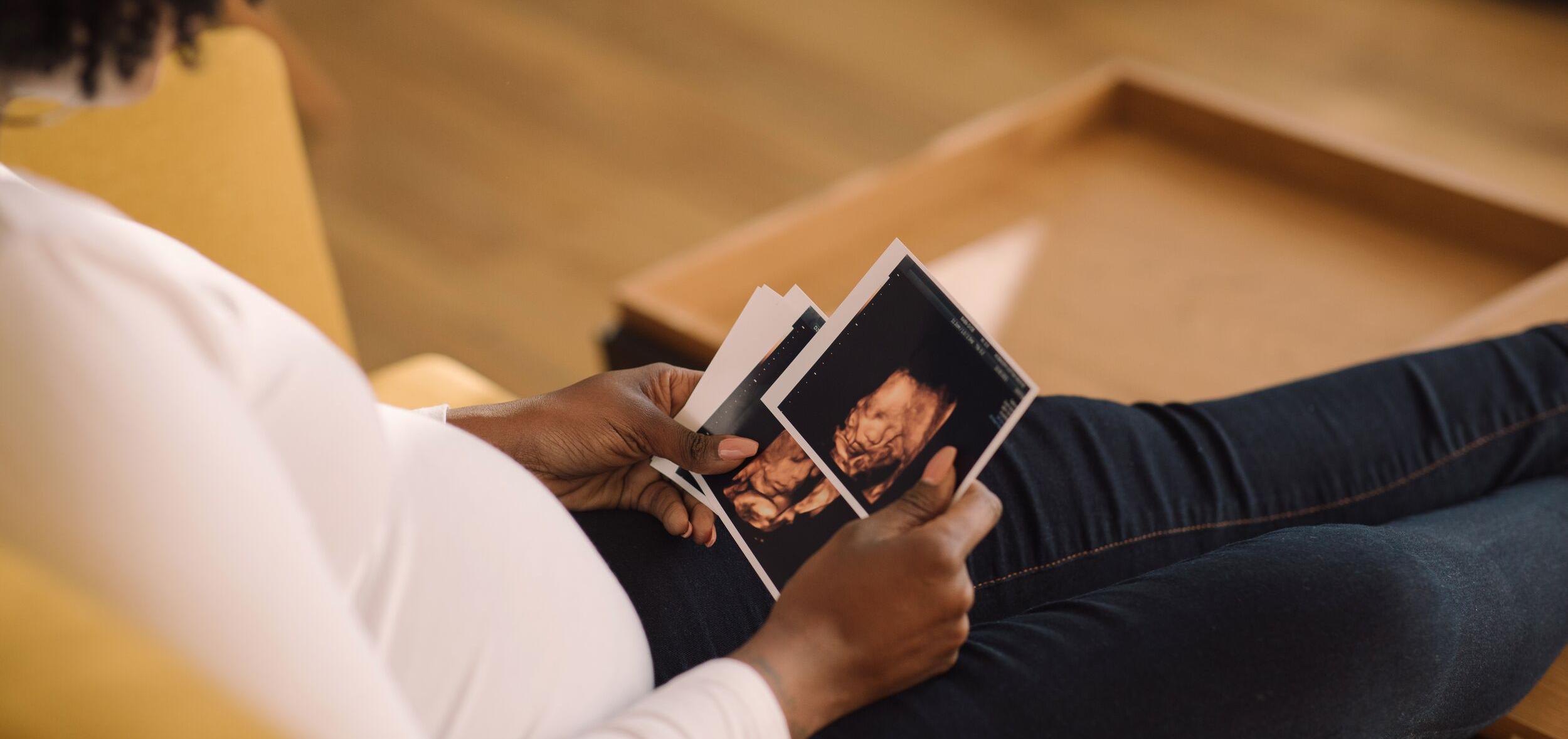 woman looking at pictures of her sonogram