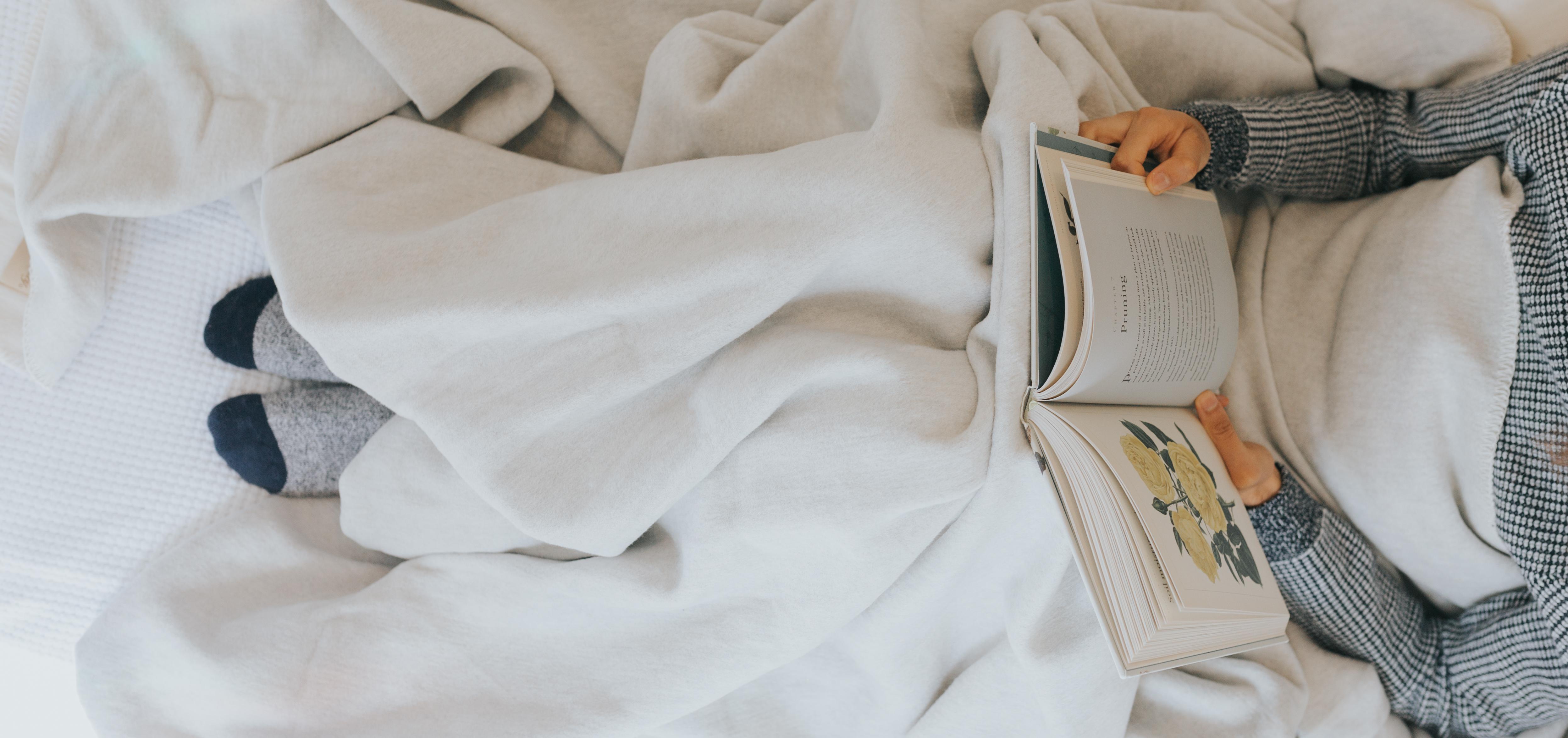 person in bed reading