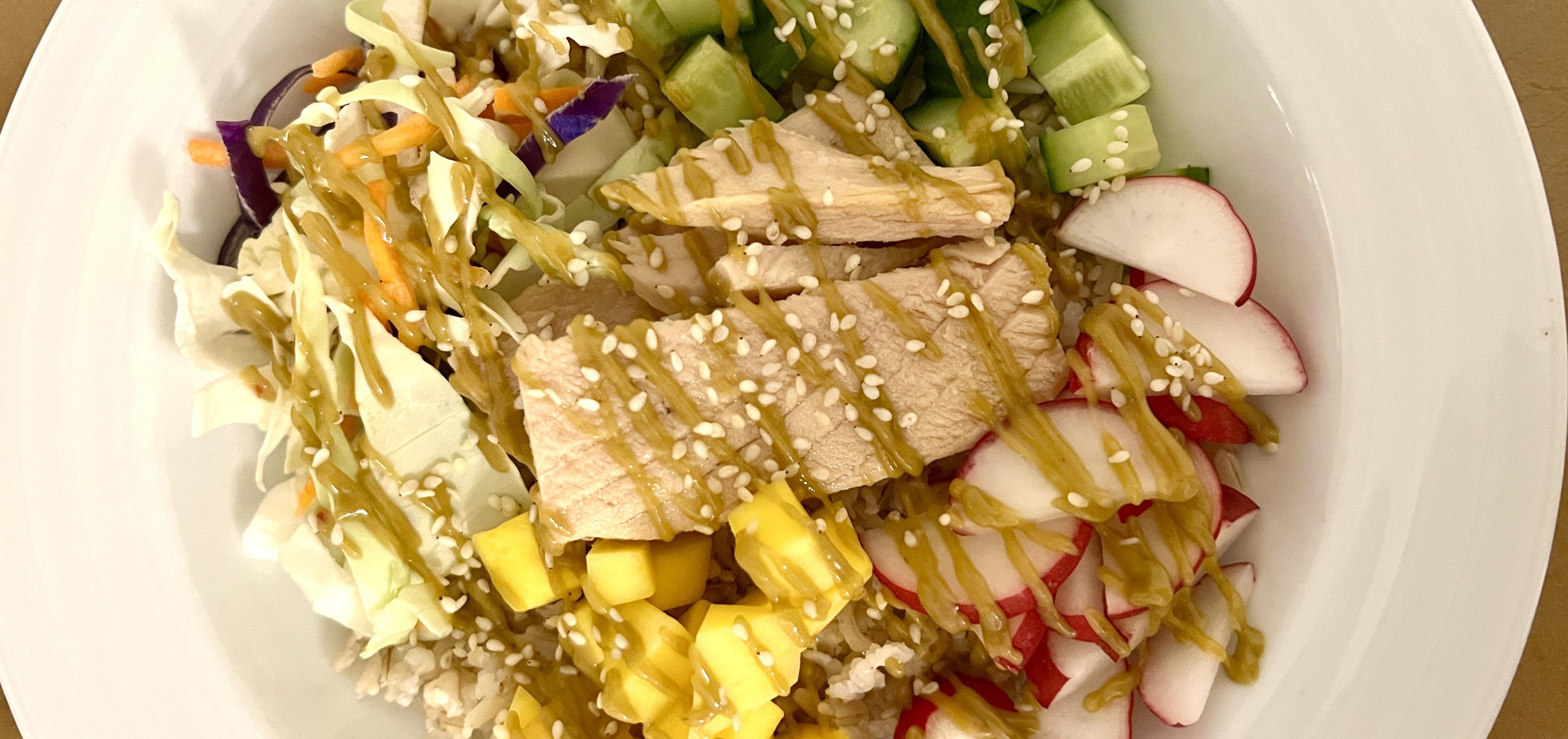 Tuna poke bowls with mango, radishes, shredded cabbage, and cucumber.