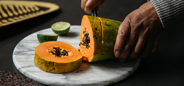 woman cutting a melon for a healthy snack