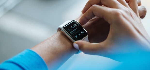 a person checking the time on their smart watch